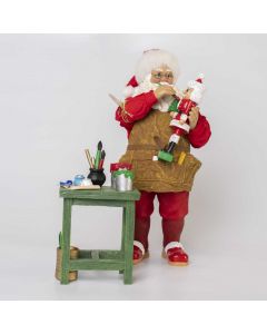 Babbo Natale dipinge i giocattoli
